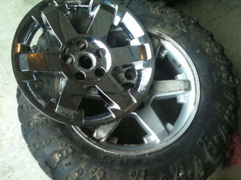 2000 Jeep TJ - A shiny chrome wheel is placed on a tire, with website text visible on the tire's sidewall.