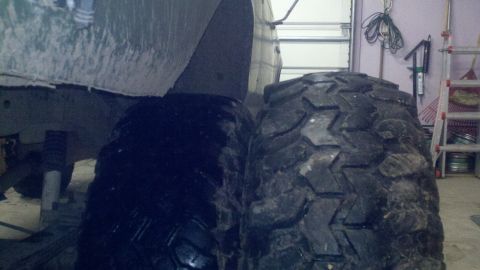 1989 Ford Bronco - Comparing tire sizes in a garage; the larger tire is on the right.