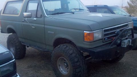 1989 Ford Bronco - This modified Ford Bronco sits high on large tires, a custom front bumper and a star decal on the hood.