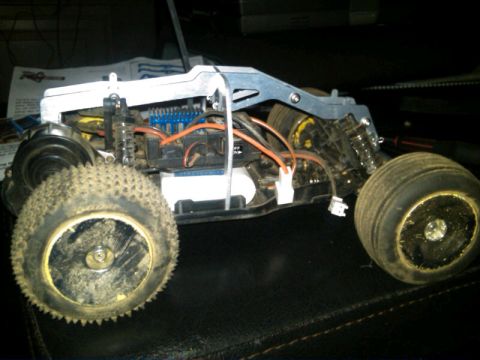 1986 Ford Bronco - Chassis of a remote control car, showing internal electronics and suspension.