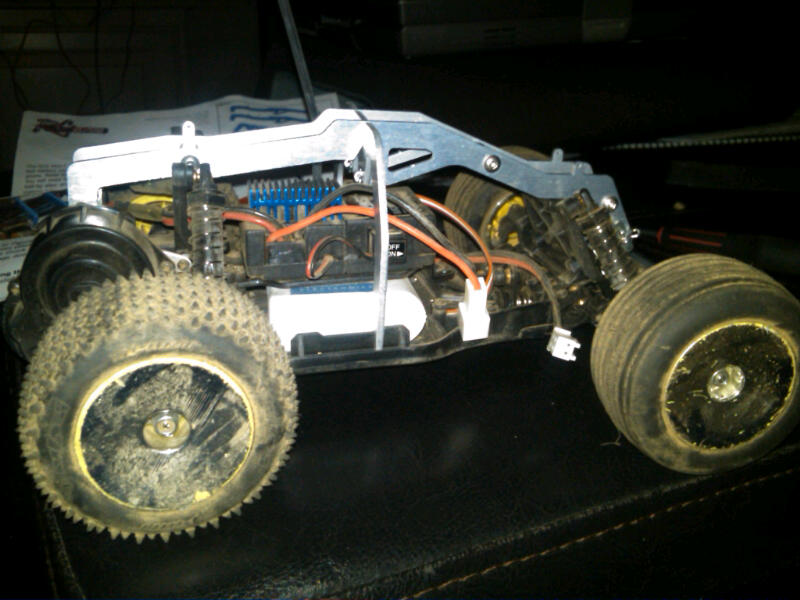 Remote control car chassis with exposed wiring and suspension components