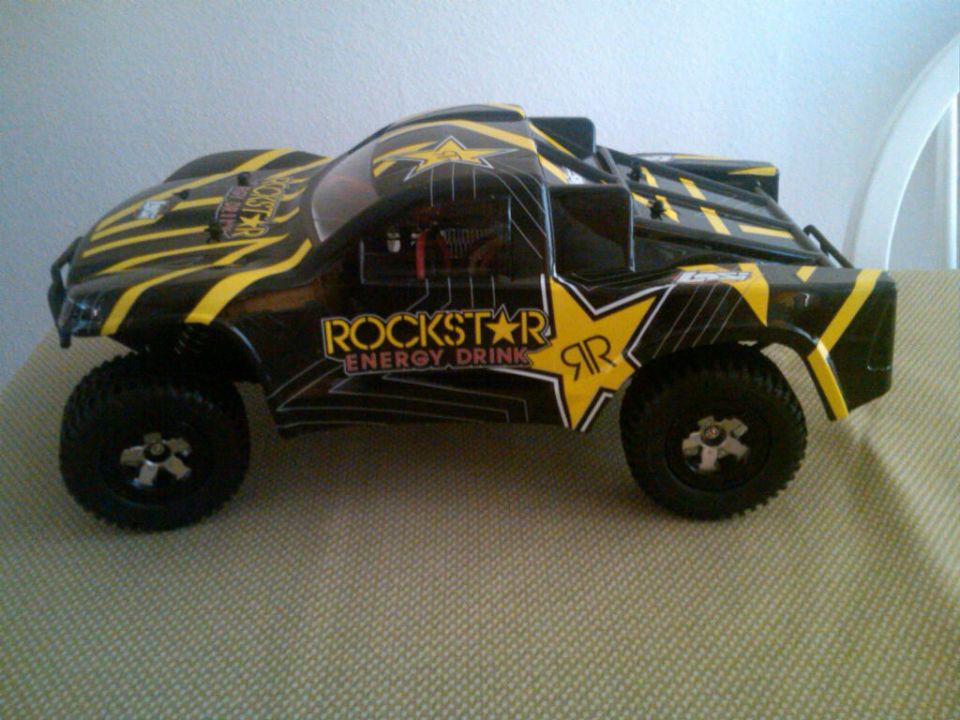Black remote control trophy truck with yellow Rockstar Energy Drink graphics