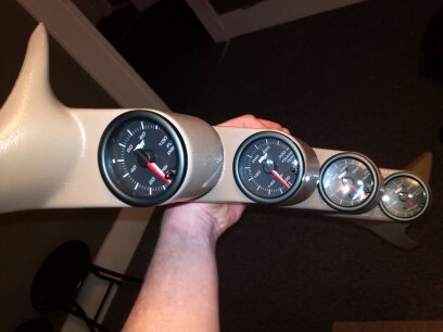 1993 Ford F-150 - A tan gauge pod with four gauges is held up for display.