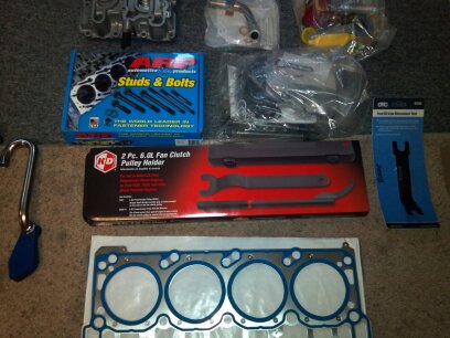 1993 Ford F-150 - Various automotive parts and tools are laid out on a carpeted surface.