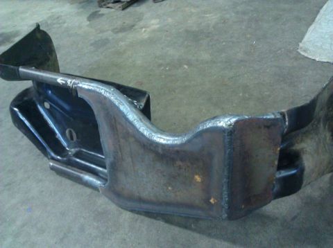 1979 Ford Bronco - A modified metal frame with extensive welding is shown from a close-up angle.