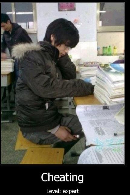 2000 Mercury Grand Marquis - A student appears to be cheating on a test by using a phone, with stacks of books on the desk.