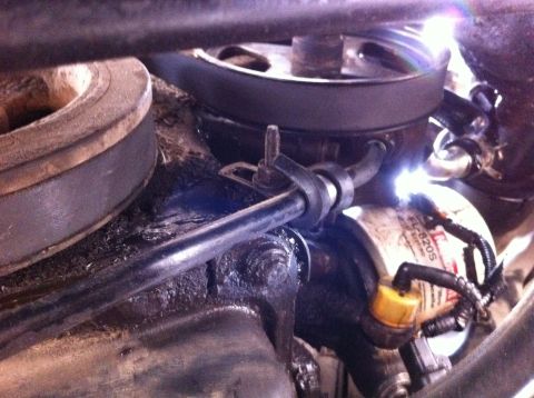 1998 Ford Crown Victoria - The oil filter is labeled FL-820S. The scene shows engine parts, not a 1998 Ford Crown Victoria.