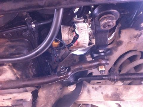 1998 Ford Crown Victoria - Undercarriage view showing suspension parts and an oil filter, likely from a Ford Crown Victoria.