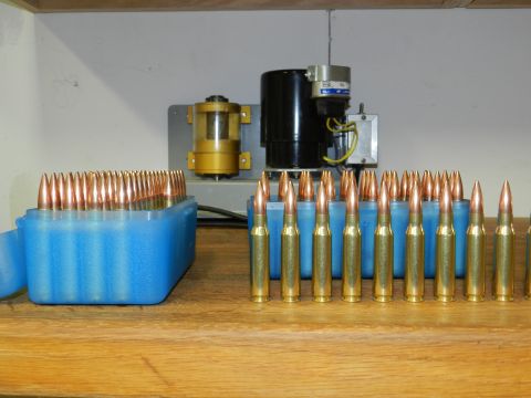 1996 Ford Bronco - A close-up view of ammunition and reloading equipment is displayed on a wooden surface.