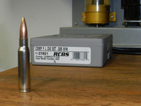 1996 Ford Bronco - A bullet and a reloading die set box are displayed on a wooden surface.