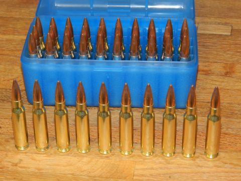 1996 Ford Bronco - A blue plastic case holds rifle cartridges, with more cartridges laid out in front.