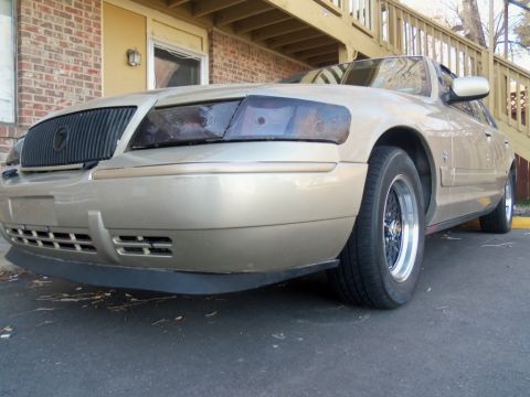 2000 Mercury Grand Marquis - Front three-quarter view of a gold 2000 Mercury Grand Marquis.