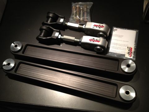 1992 Ford Crown Victoria - Metco adjustable control arms and hardware kit shown laid out on a dark surface.