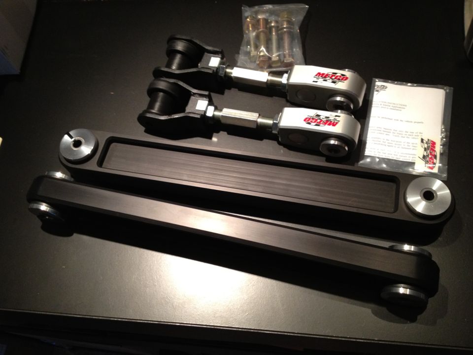 Metco adjustable control arms and hardware on a dark surface