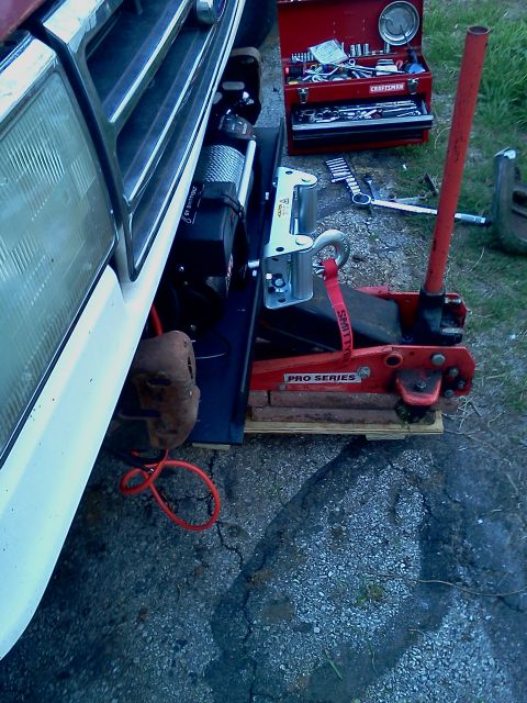 1989 Ford Bronco - Front view of a 1989 Ford Bronco showing a winch mount, jack, and toolbox nearby.