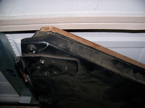 2000 Jeep Wrangler - Close-up view of a vehicle's door hinge and frame, with visible mounting hardware.