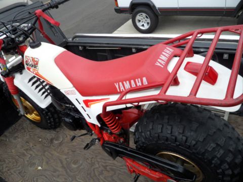 1994 Jeep Cherokee - Yamaha 3-wheeler with '200' and 'Yamaha' branding visible, parked next to a Jeep Cherokee.