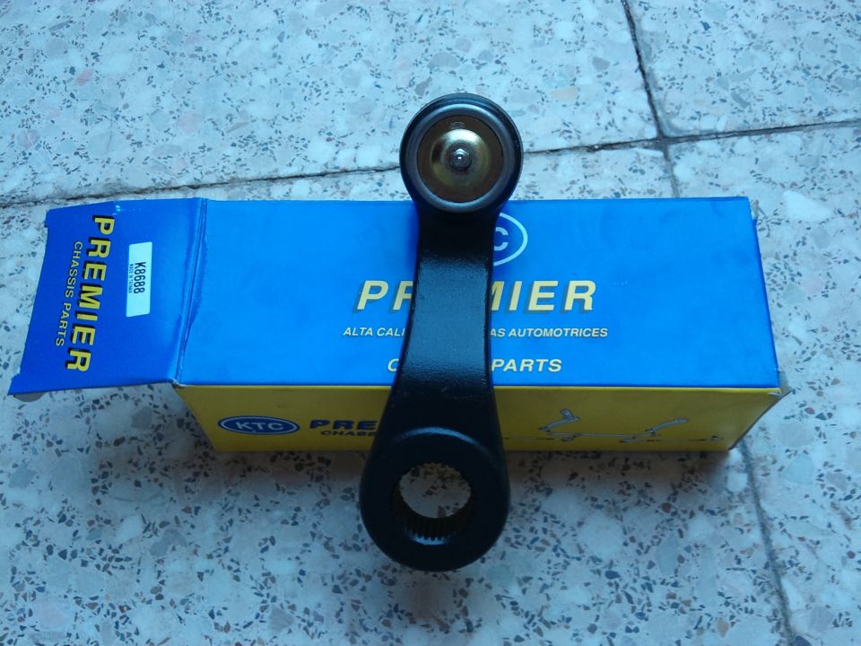 Black steering linkage part on Premier Chassis Parts box
