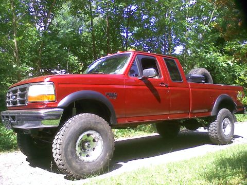 1996 Ford F-250 - This red 1996 Ford F-250 pickup truck is shown from a 3/4 front angle.