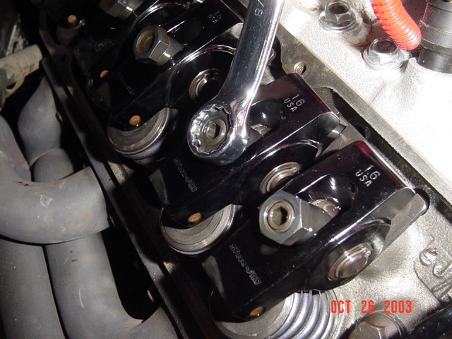 Line up the rotor to the cylinder you want to work on.. then loosen the nut holding the rocker