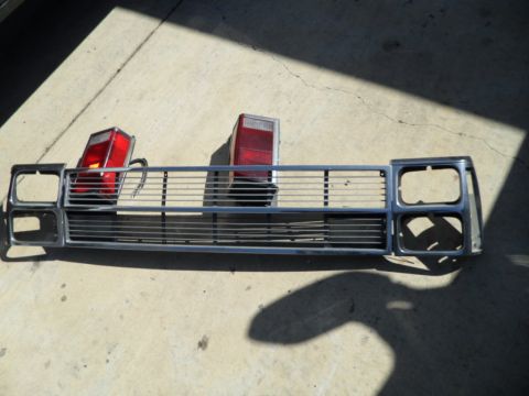 1994 Jeep Cherokee - Grille and taillights from a Jeep Cherokee are displayed on a concrete surface.