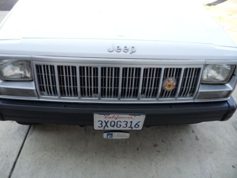 1994 Jeep Cherokee - Front view of a 1994 Jeep Cherokee, showing its distinctive grille and headlights. The California license plate is visible.