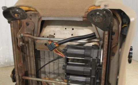 2007 Ford F-250 - The complex mechanism beneath a vehicle seat, multiple electric motors and wiring harnesses.