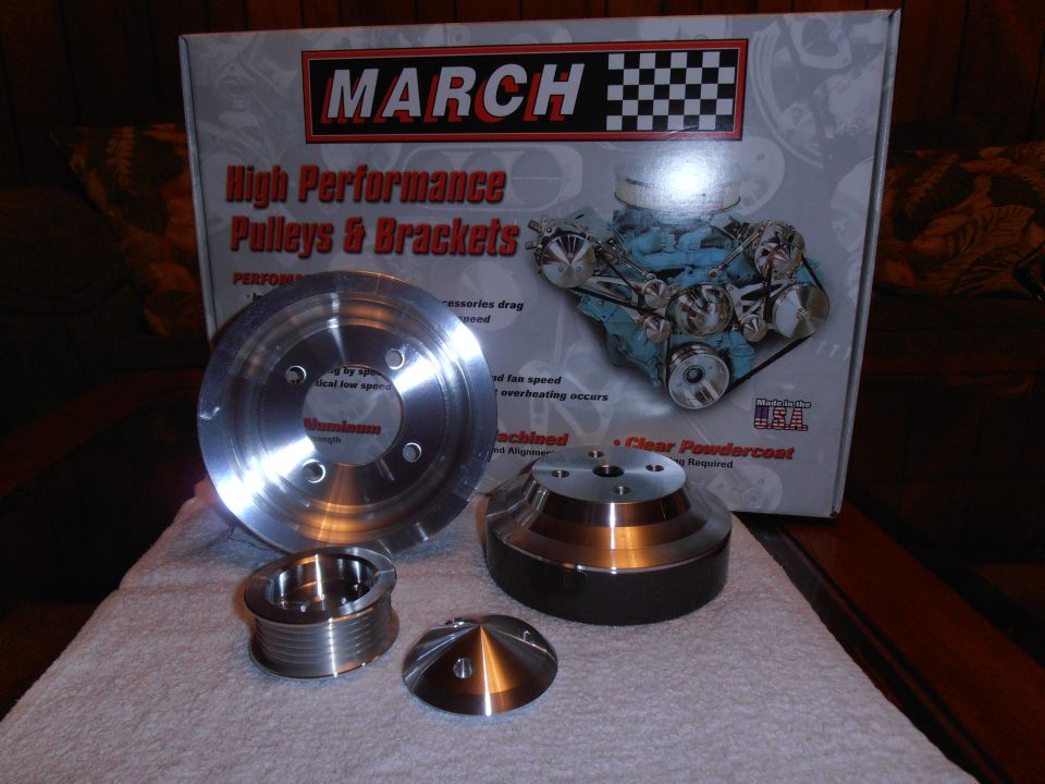 March Performance High Performance Pulleys & Brackets box with aluminum pulleys and brackets displayed on a white cloth