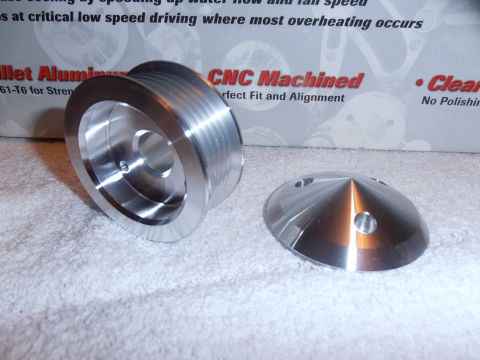1990 Ford Bronco - Two billet aluminum parts, a pulley and a cover, are displayed on a textured surface with text in the background.