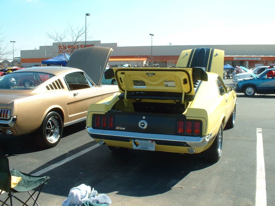 Yellow 1970 Ford Mustang Mach 1 rear view with trunk open