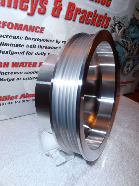 1990 Ford Bronco - Close-up of a billet aluminum pulley, likely for an engine, with product information visible in the background.