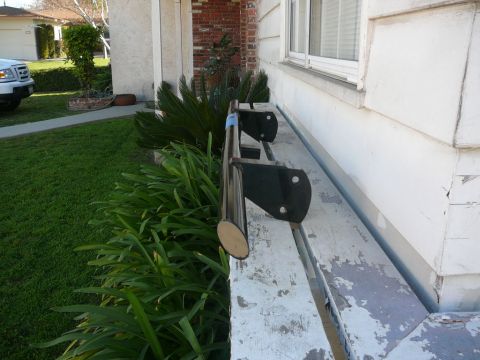 1988 Ford Bronco - A white truck is visible in the background next to a house with a metal railing.