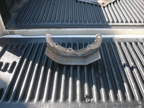 1988 Ford Bronco - A custom metal bracket is shown resting in the ribbed bed of a pickup truck.