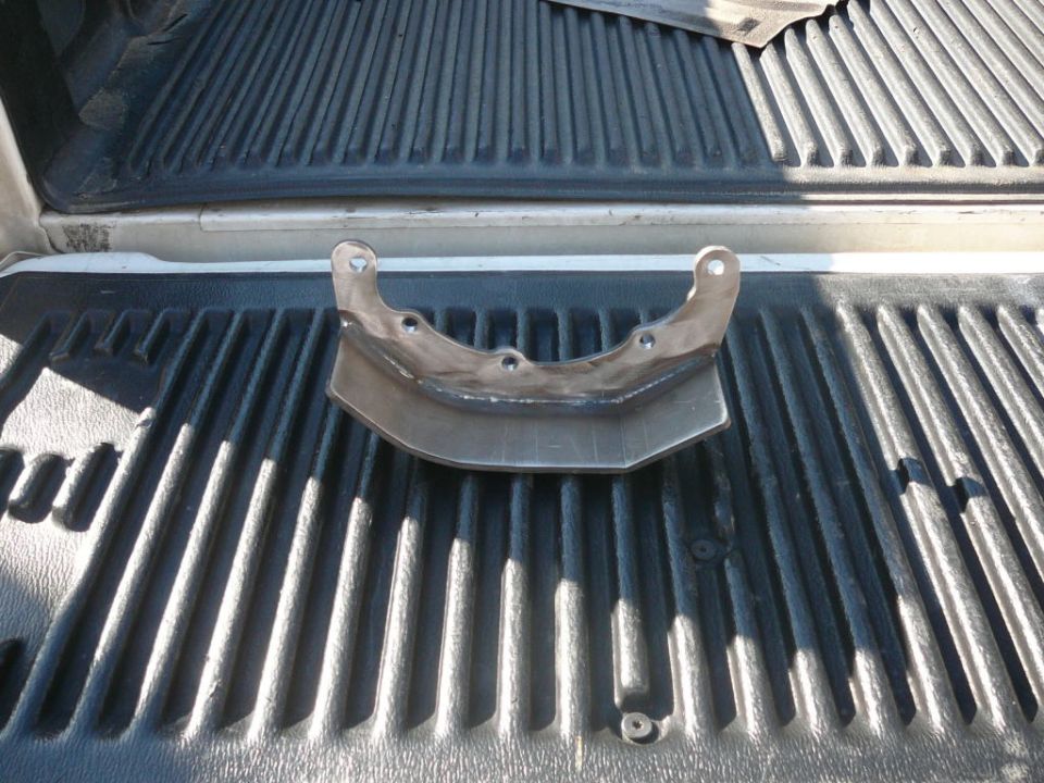 Metal bracket with mounting holes in truck bed
