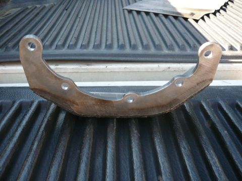 1988 Ford Bronco - Unidentified metal suspension component shown on a truck bed.
