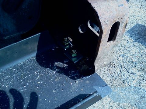 1989 Ford Bronco - Close-up view of winch mount hardware, showing bolts and nuts secured to a metal bracket.