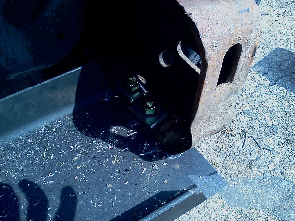 Winch mount hardware with bolts and nuts attached to a metal bracket