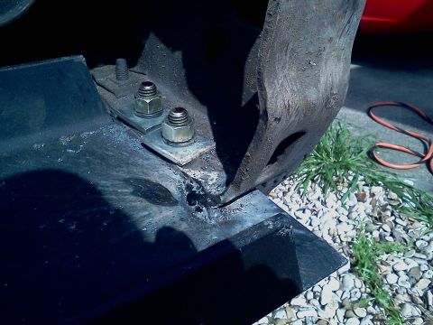 1989 Ford Bronco - Close-up view of hardware used for mounting a winch bracket, showing bolts and nuts on metal plates.