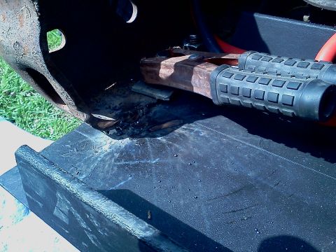 1989 Ford Bronco - Close-up of a winch mount with visible rust and textured grips.