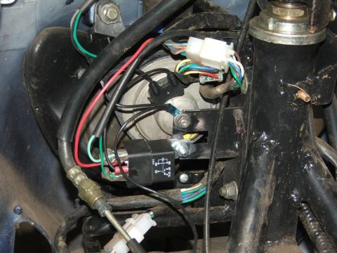 2008 Yamaha Zuma - This image shows the intricate electrical system of a motorcycle, including various wires, a relay, and connectors.