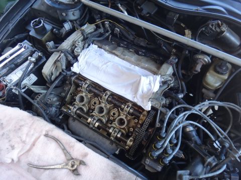 1993 Ford Taurus - The engine compartment of a car is shown with the valve cover removed for maintenance.