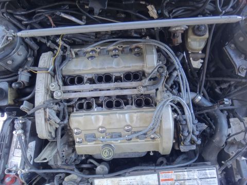 1993 Ford Taurus - Engine bay view of a V6 engine, showing fuel rails, intake manifold, and spark plug wires.