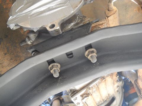 1992 Ford Explorer - Undercarriage view shows heavily corroded bolts securing a vehicle's frame components.