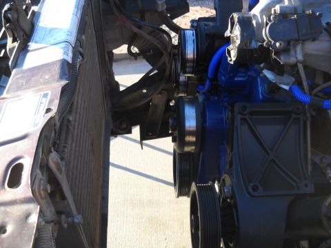 1992 Ford Explorer - The engine block is painted blue, with multiple pulleys visible near the radiator.