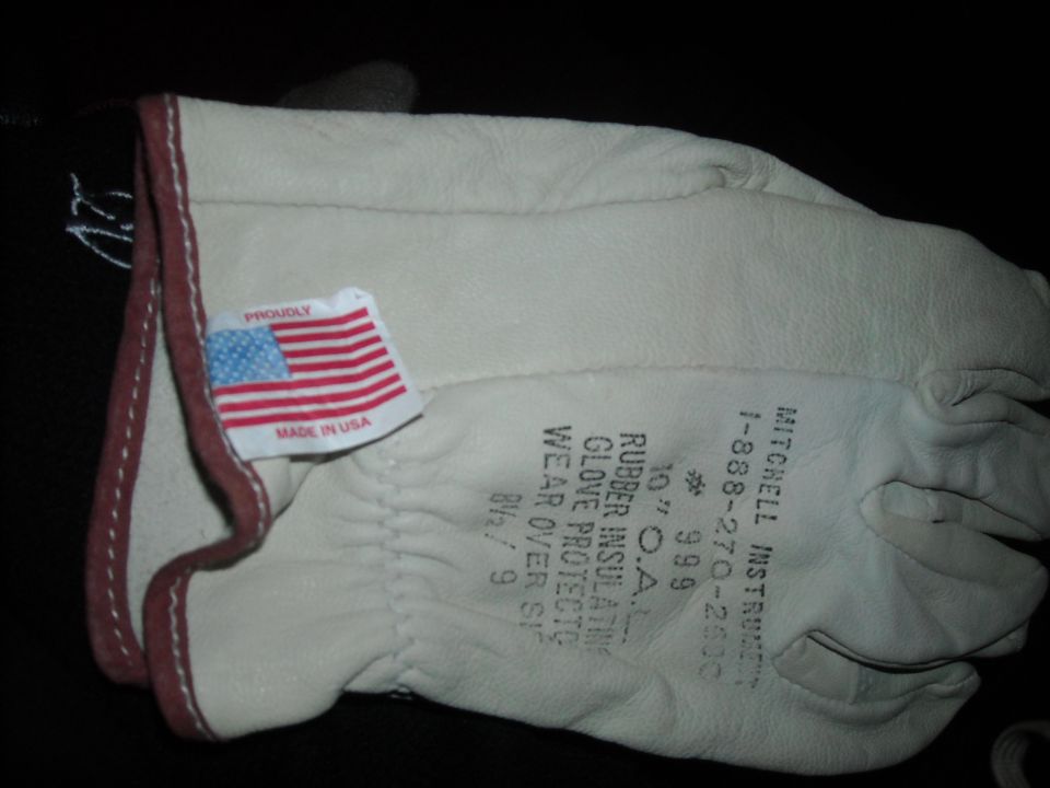 Pair of white leather work gloves with a 'Proudly Made in USA' tag and text detailing glove specs