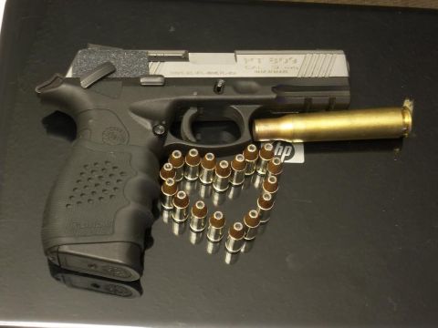 2000 Mercury Grand Marquis - A handgun and ammunition are laid out on a dark surface, with a partial HP logo visible.