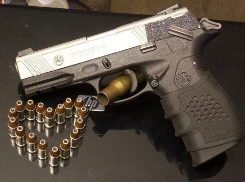 2000 Mercury Grand Marquis - A Taurus pistol is displayed with ammunition arranged in a heart shape, and a bullet chambered.