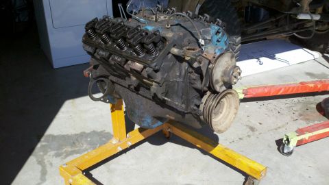 1978 Ford Bronco - Engine on stand, likely for rebuild or repair, with visible V8 components.