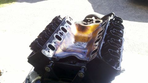 1978 Ford Bronco - Engine with oil pooled in the intake manifold, likely during a motor rebuild.