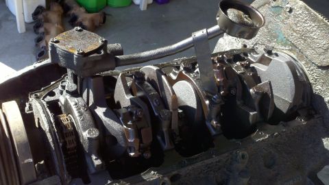 1978 Ford Bronco - Close-up view of an engine block's internal components, including the crankshaft and oil pump.